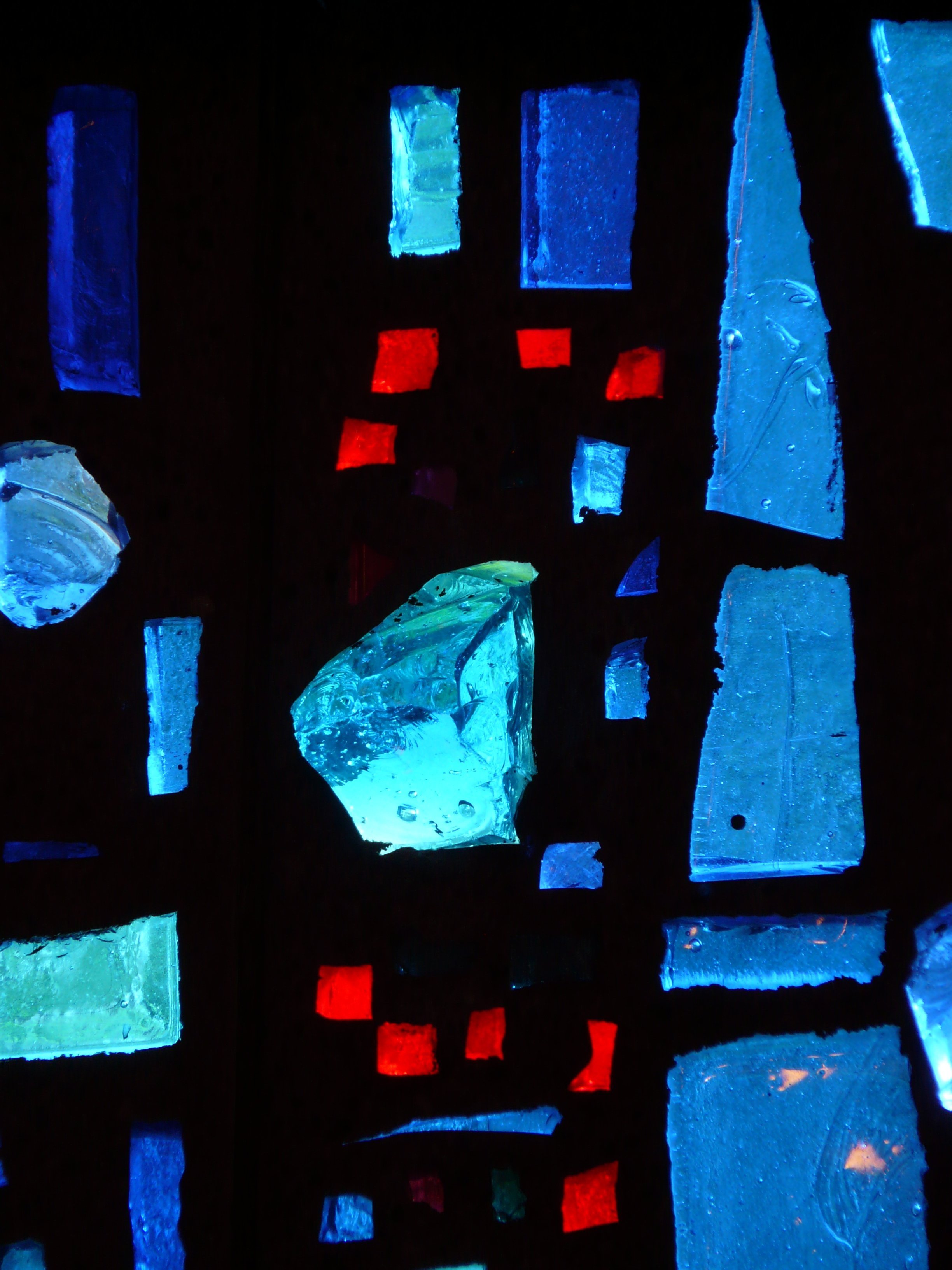 Abstract close-up of blue and red stained glass pieces